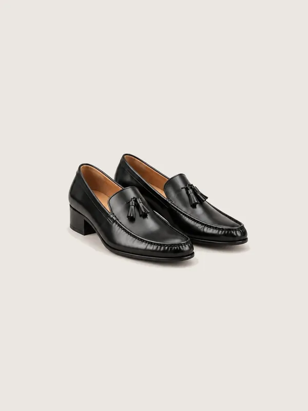 AI-generated product photo of the black tassel loafers, one of the pieces in the Someone Shop.